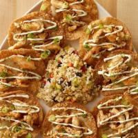 Asian Nachos · Crispy Fried Wontons Covered with Chicken in a Sweet-Hot Peanut Sauce. Topped with Melted Ch...