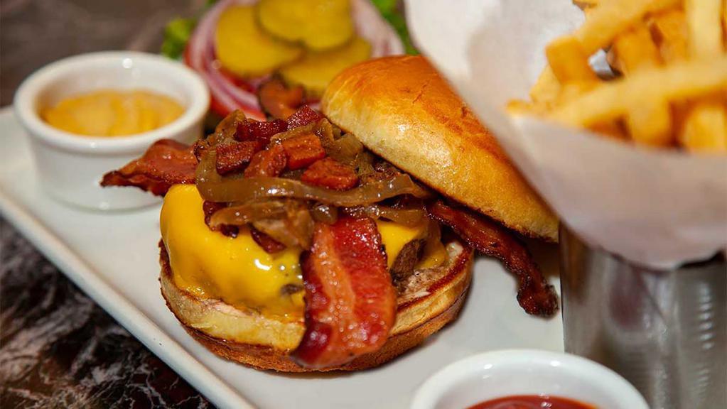 The Bacon-Cheese Burger · Topped with Crisp Applewood Smoked Bacon, Melted American Cheese, Grilled Onions and Thousand Island