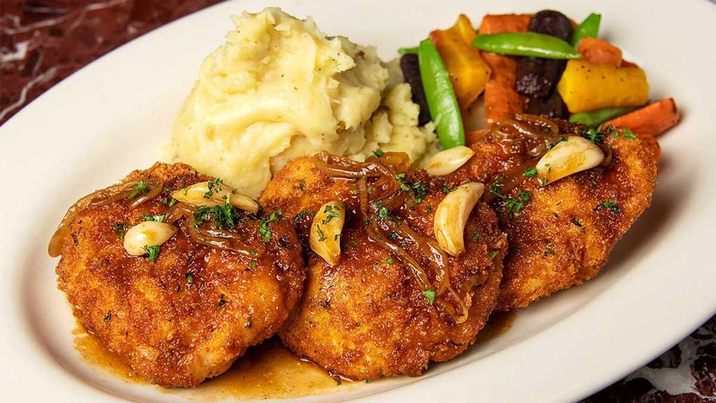 Garlic Chicken · Chicken Breasts Stuffed with Garlic Butter and Parmesan, Lightly Breaded and Fried Crisp. Served with Red Wine Roasted Garlic Sauce, Mashed Potatoes and Fresh Vegetables