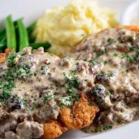 Chicken Fried Chicken · Crispy Coated Chicken Breast Smothered with Sausage Gravy and Served with Mashed Potatoes an...