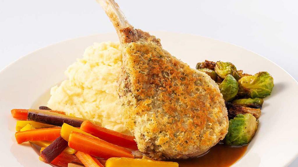 Parmesan Crusted Pork Chop · Thick-Cut Pork Chop Topped with Garlic Buttered Breadcrumbs, Parmesan Cheese and Fresh Herbs. Served with Mashed Potatoes, Crispy Brussels Sprouts and Roasted Carrots