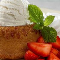 Warm Butter Cake · Warm Buttery Vanilla Cake with a Rich Creamy Center, Served with Fresh Strawberries and Vani...