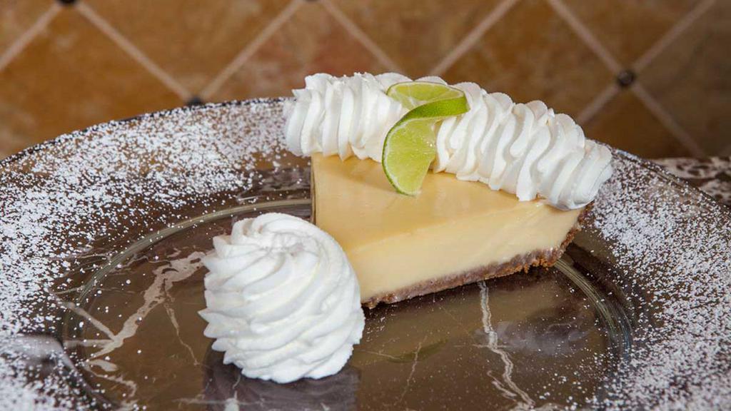 Key Lime Pie · Baked Fresh with a Graham-Pecan Crust. Topped with Fresh Whipped Cream