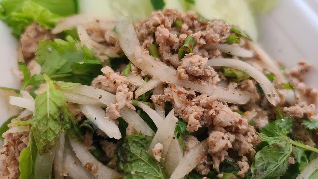 Larb · A traditional Lao and Northern Thai dish. Minced chicken, beef, or pork tossed together with lemon juice, roasted rice powder, onion, cilantro, and mint leaves.