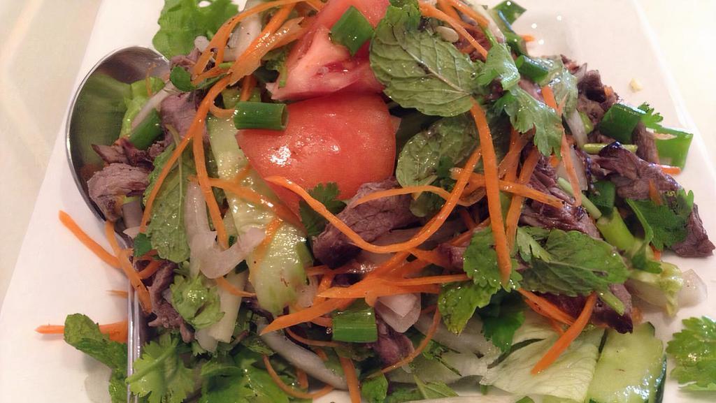 Thai Beef Salad · Grilled beef tossed with cucumber, carrot, onion, cilantro and a fresh tangy lemon juice dressing. Prepared mild, medium or hot.