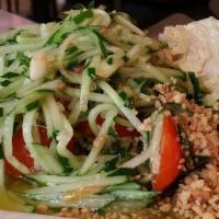 Cucumber Salad · Shredded fresh cucumber, tomatoes and a lime dressing. Topped with crushed peanuts. Prepared...