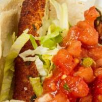 Fish Soft Taco · Seasoned fried tilapia, lettuce, and pico de gallo. All topped with onions and cilantro, on ...