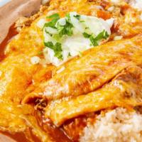 Chicken Enchilada · served with rice and refried beans, topped with sour cream, onion and cilantro