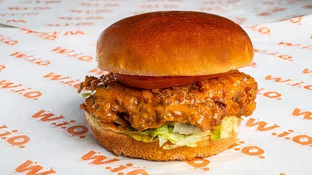 Buffalo Chicken Sandwich · Crispy buttermilk chicken tossed in mild buffalo sauce. Served with lettuce, tomato and blue cheese dressing.