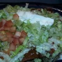Pork Enchiladas · Three pork enchiladas covered with guacamole sauce and swiss cheese.