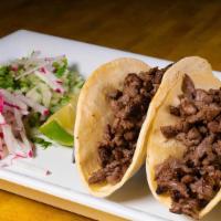 El Patron Taco · Tortillas stuffed with rib eye steak, grilled onions, guacamole. Served with cactus.
