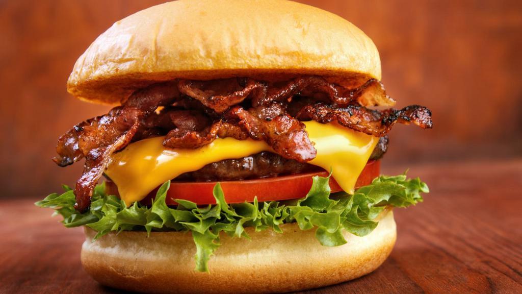 Bacon Burger · Juicy, grilled beef burger and crispy bacon with fresh lettuce, tomatoes, pickles, ketchup and mayo on a toasted buttery bun. Your choice of toppings.