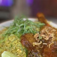 Duck N’ Rice · Fall of the bone duck leg confit served with aromatic turmeric, raisin, coconut rice and cas...