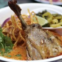 Khao Soi · Chiang Mai curried thick egg noodles with duck leg confit, and pickled condiments.