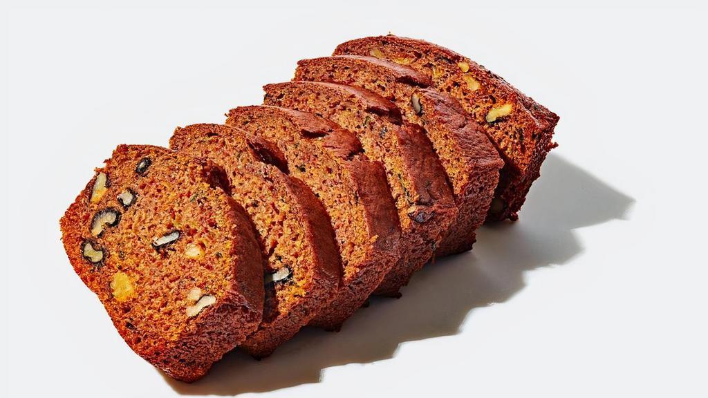 Zucchini Bread (V) · Made with zucchini, walnuts, apple sauce, flour, baking soda, baking powder, sugar, canola oil, vanilla, salt, cinnamon, nutmeg, and cardamom, this single serve pound cake is baked fresh with love for you!