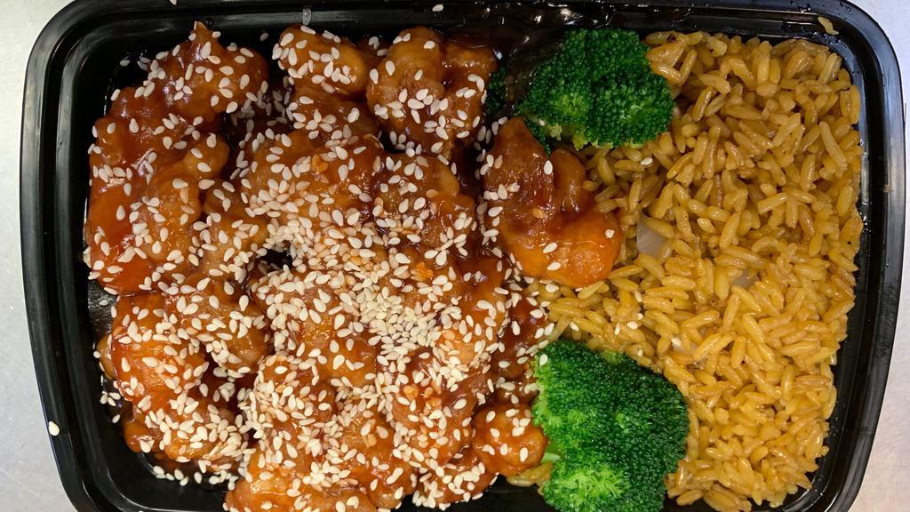 Sesame Chicken · Lightly battered chicken chunks garnish with steamed broccoli and sauteed with tangy sauce top with sesame seeds.