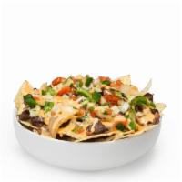 Nachos · Choice of protein, toppings and covered with creamy queso.