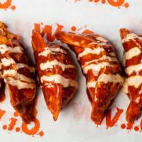 Nashville Hot Veggie Dumplings · Tossed in our Nashville Hot then drizzled with Chipotle Ranch