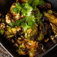 Charred Brussels Sprouts · Cilantro lime vinaigrette, puffed rice.