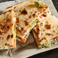 Quesadilla · Topped with Cheese and Sour Cream. Served with Side Salad.