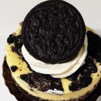 Oreo Cheesecake · Creamy Vanilla Bean Cheesecake with Oreo's baked in & topped with buttercream & an Oreo.