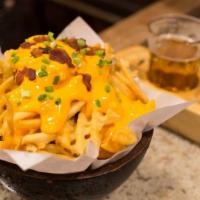Bacon Bits & Cheez Whiz Fries · Golden-crispy fries topped with bacon bits and melted cheese.