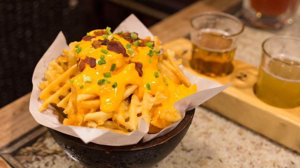 Bacon Bits & Cheez Whiz Fries · Golden-crispy fries topped with bacon bits and melted cheese.