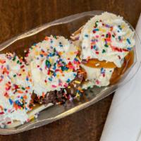 Banana Split · Three scoops with a banana, hot fudge and/or hot caramel, three dry toppings and whip cream.