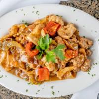 Chicken Scarpariello · Sautéed chicken with hot and, or sweet vinegar peppers, sausage and sliced potatoes in a gar...