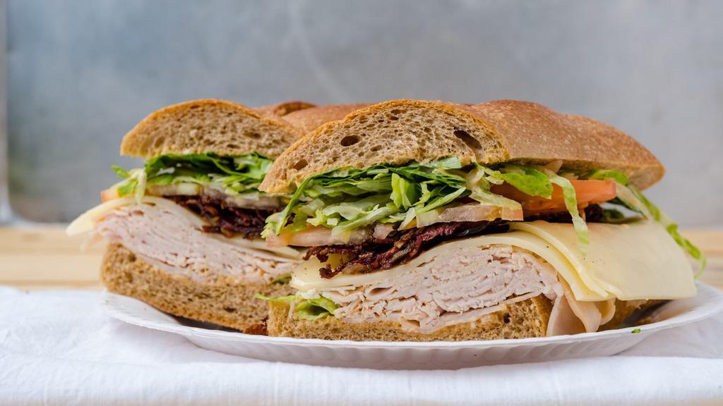Turkey Club Sandwich · Oven gold turkey. beef, Swiss cheese, bacon, lettuce, tomato and Russian dressing.