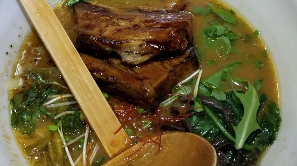 Tonkotsu Shoyu · Pork Broth, Roasted Pork Belly, green cabbage, Kikurage, Menma Bamboo (Lactate Fermented Bamboo Shoots), Spinach, Arugula, Scallion, Black Garlic Oil.