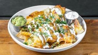 Nachos - Mexican Style · Blend of Jack and Cheddar cheeses, jalapeños, sour cream, pico de gallo. Served with sour cr...