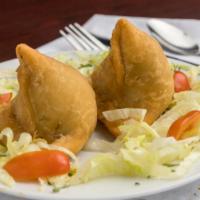 Samosa  · Crispy, deep fried turnovers filled with potatoes, green peas, flavored with fresh coriander...