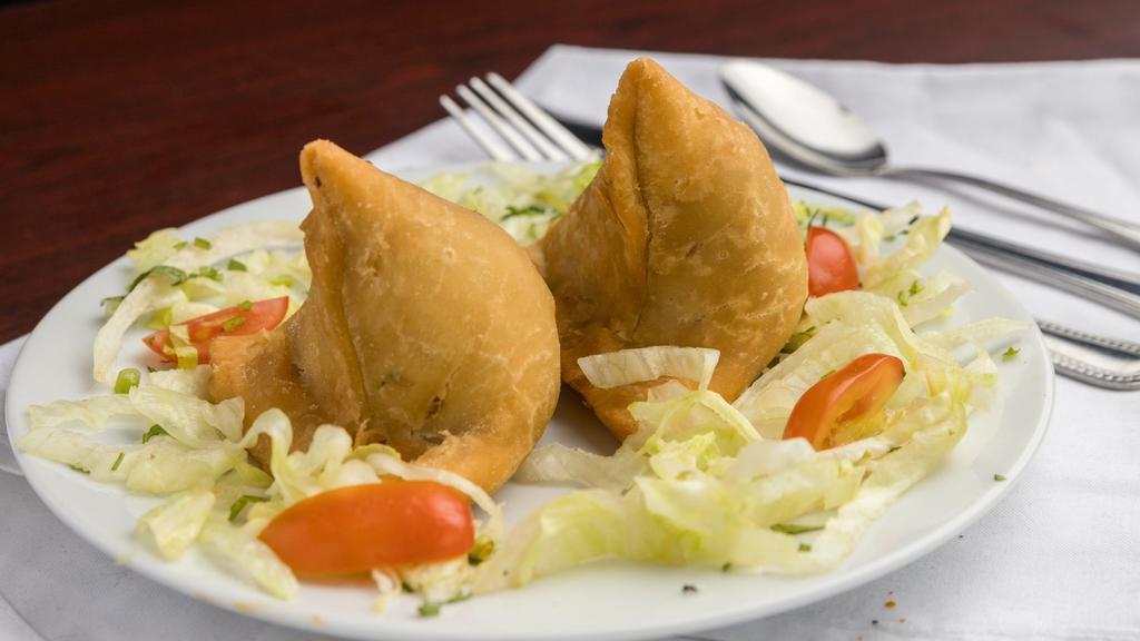 Samosa  · Crispy, deep fried turnovers filled with potatoes, green peas, flavored with fresh coriander & spices