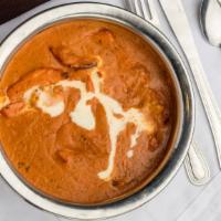 Butter Chicken · A timeless favorite. Chunks of chicken cooked in a smooth butter & tomato based gravy, flavo...