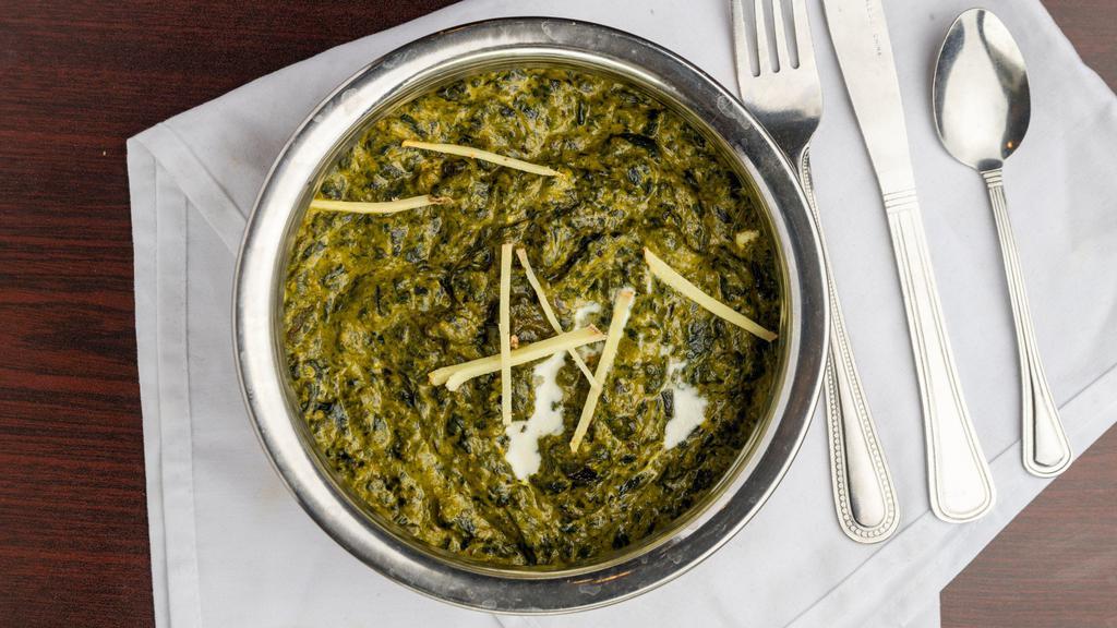 Palak Paneer · Indian cottage cheese cubes cooked along with smooth spinach gravy & enhanced with cream & spices