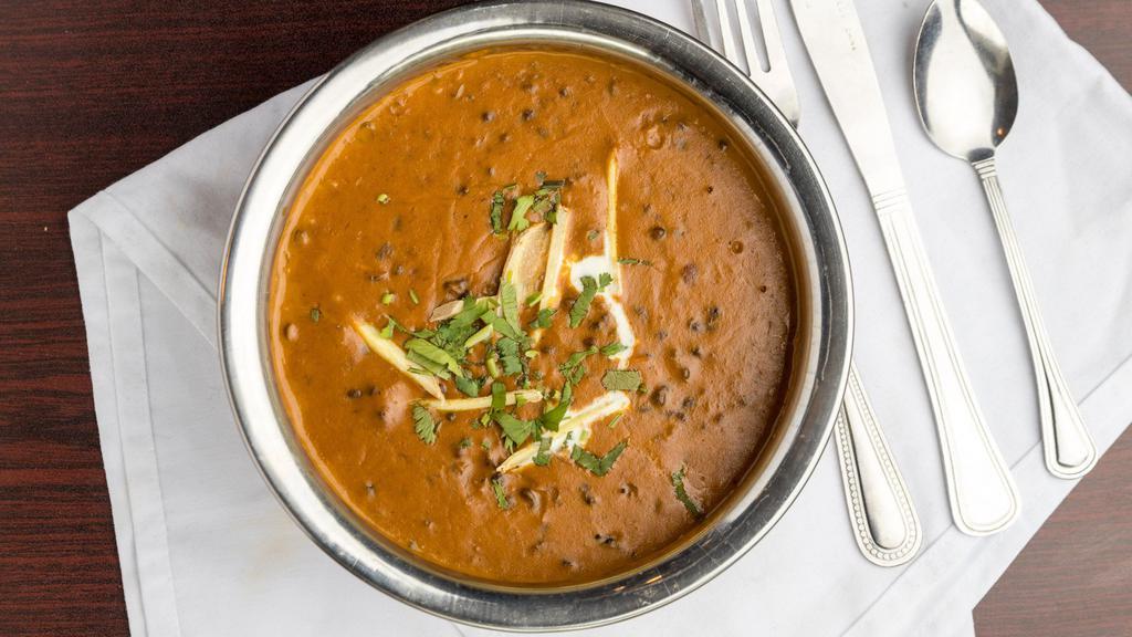 Dal Makhani · A harmonious blend of black lentils, tomatoes, ginger & garlic, simmered till perfection . Finished with cream & served with a dollop of unsalted butter