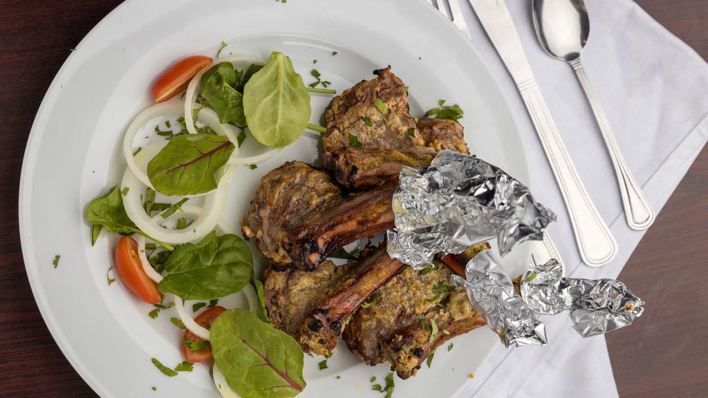 Lamb Chop · Tender bone-in lamb meat chops marinated in strained yogurt and flavorsome masalas, roasted till tender