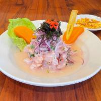 Ceviche De Pescado · Chopped fish marinated in lemon juice served with sweet potato and onions.