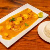 Salmon En Salsa De Camarones · Grilled salmon topped with shrimp in a garlic butter sauce served with white rice.