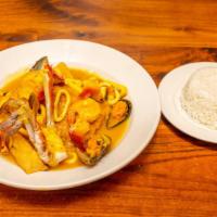 Pescado A Lo Macho · Fried fish, topped with a seafood sauce served with white rice and yucca.
