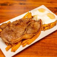 Bisteck A Lo Pobre · Grilled steak served with rice, fried eggs, fried plantain and French fries.