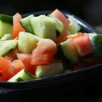 Israeli Salad · Freshly chopped tomato, Persian cucumber, and parsley flakes, with a 4 oz. lemon olive oil d...