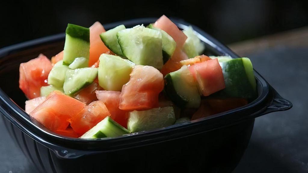 Israeli Salad · Freshly chopped tomato, Persian cucumber, and parsley flakes, with a 4 oz. lemon olive oil dressings on the side.