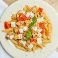 Rigatoni Pollo Caprese · Sautéed pieces of chicken with fresh tomato basil sauce And fresh mozzarella in a garlic win...