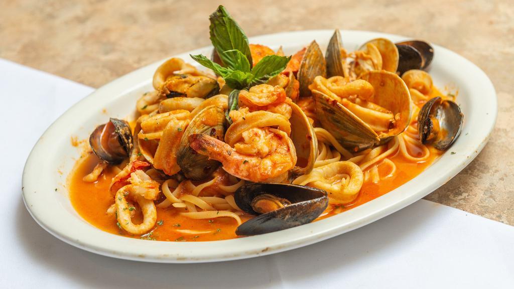 Linguine Pescatore · Calamari, Shrimp, mussels, and Clams in a rich plum tomato sauce.