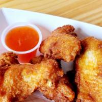 Chicken Wings · Fried chicken wings served with Thai sweet chili sauce.