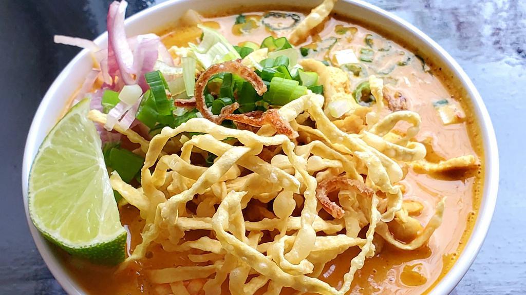Khao Soi · Northern Thai Noodles the name is Kao Soi serve w/ egg noodle, pickled cabbage, red onion,lime and crispy noodle