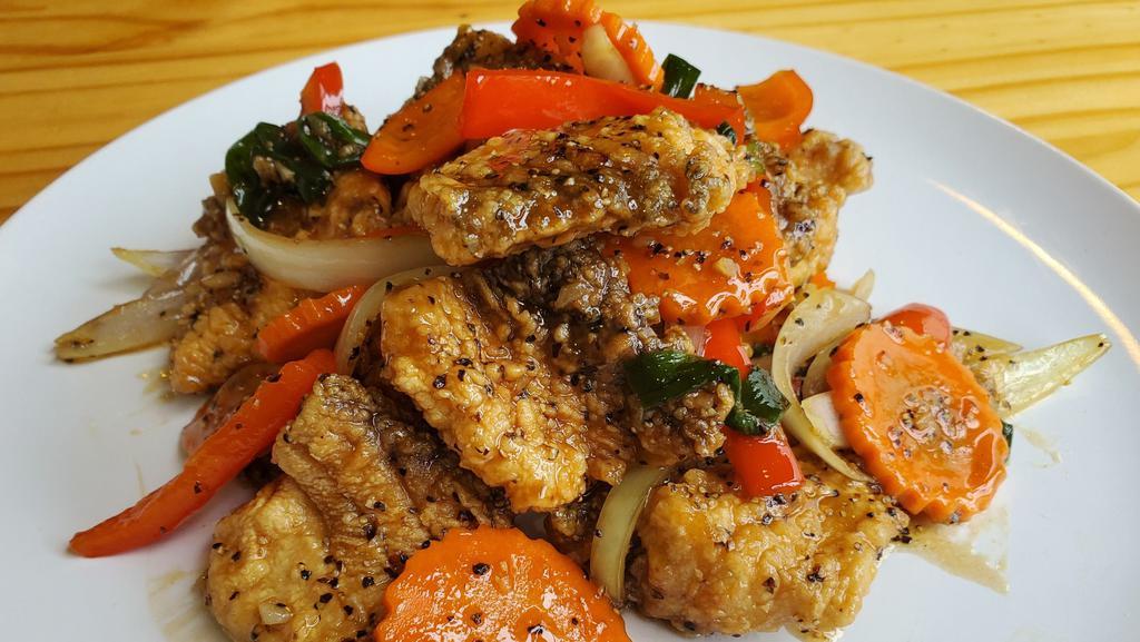 Pla Pad Black Pepper · Fried fillet of red snapper, stir-fried with Thai style fresh garlic, black pepper, carrot, onion, scallion, bell pepper, and house sauce. Come with Jasmine rice.
