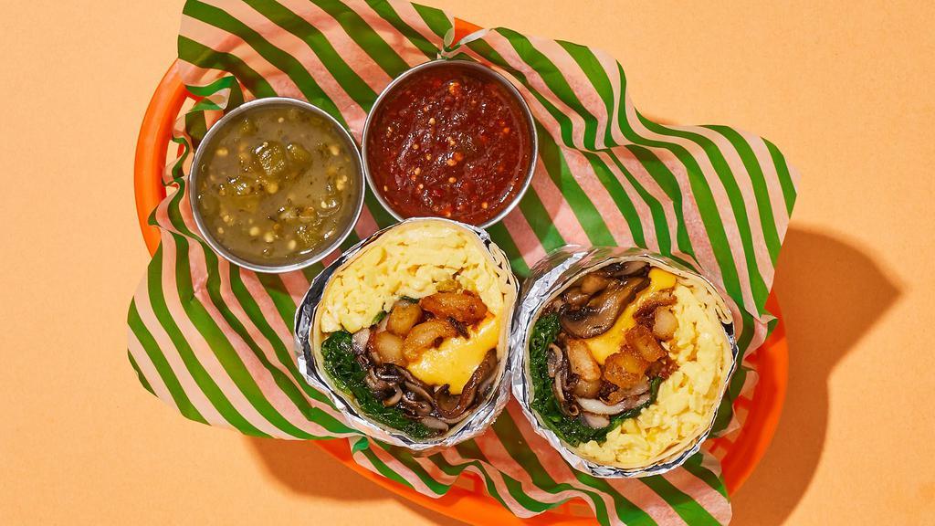 Snuggly Spinach And Mushroom Breakfast Burrito · Two scrambled eggs with crispy potatoes, melted cheese, spinach, and mushrooms wrapped up in a flour tortilla.